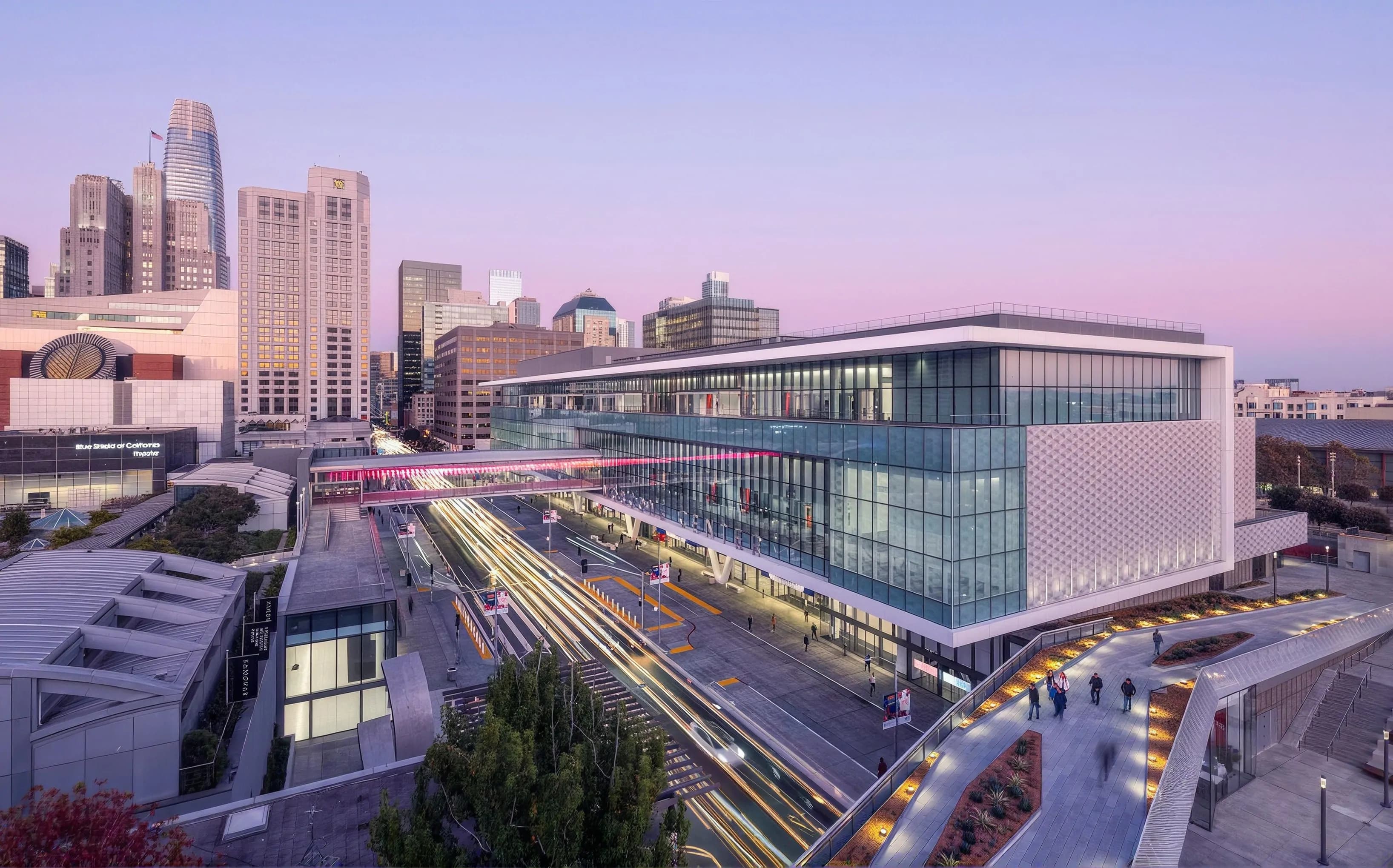 Aerial view of a modern civic centre and transit hub in a city at dusk